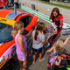 Straus signing autographs for a group of people, mostly young girls. Photo credit: Wes Duenkel, used with permission